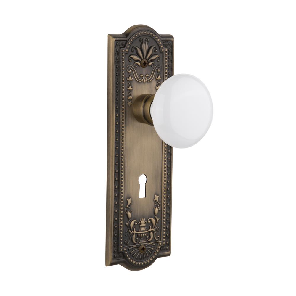 Nostalgic Warehouse MEAWHI Passage Knob Meadows Plate with White Porcelain Knob and Keyhole in Antique Brass